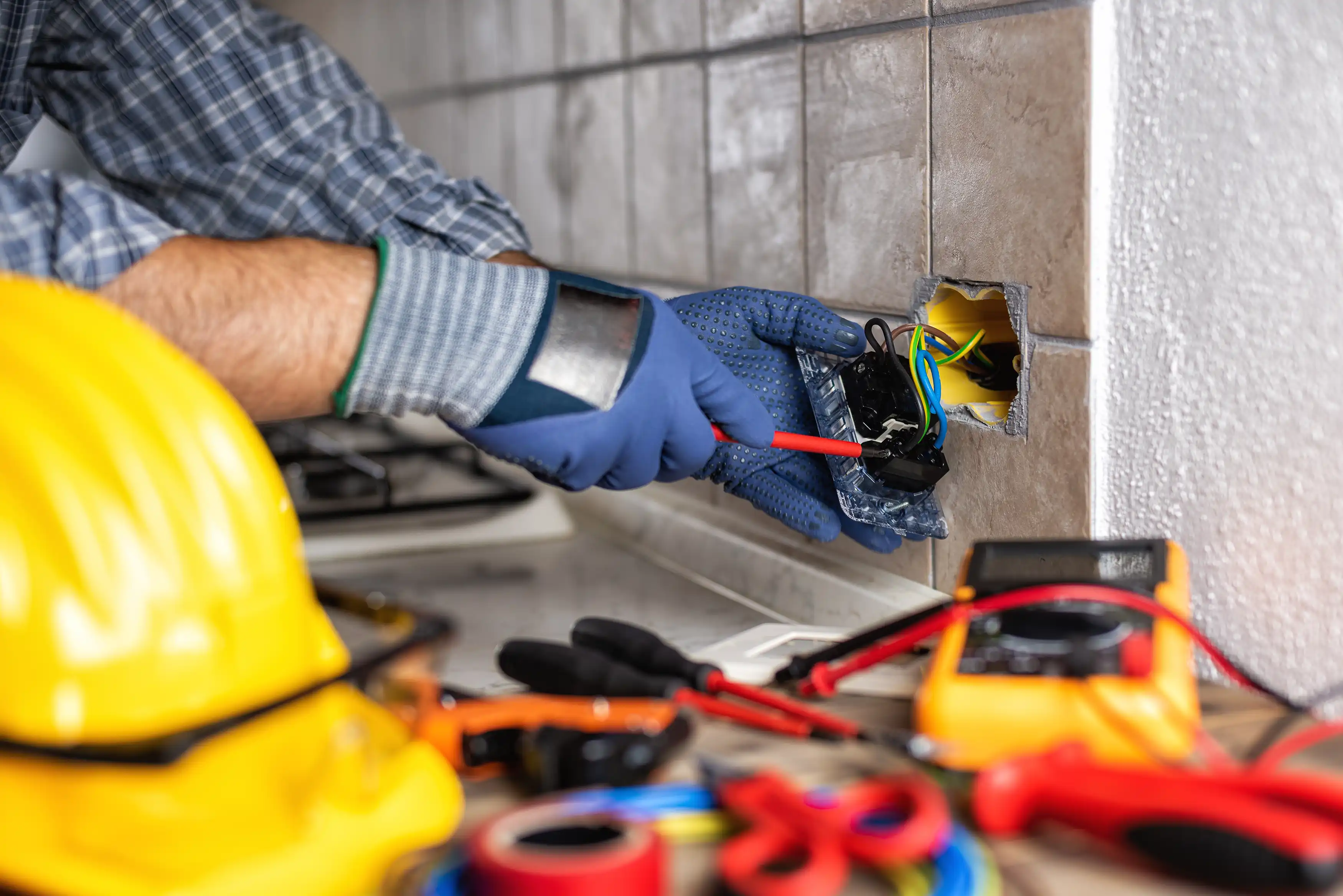Urban Electric electrician wiring an outlet